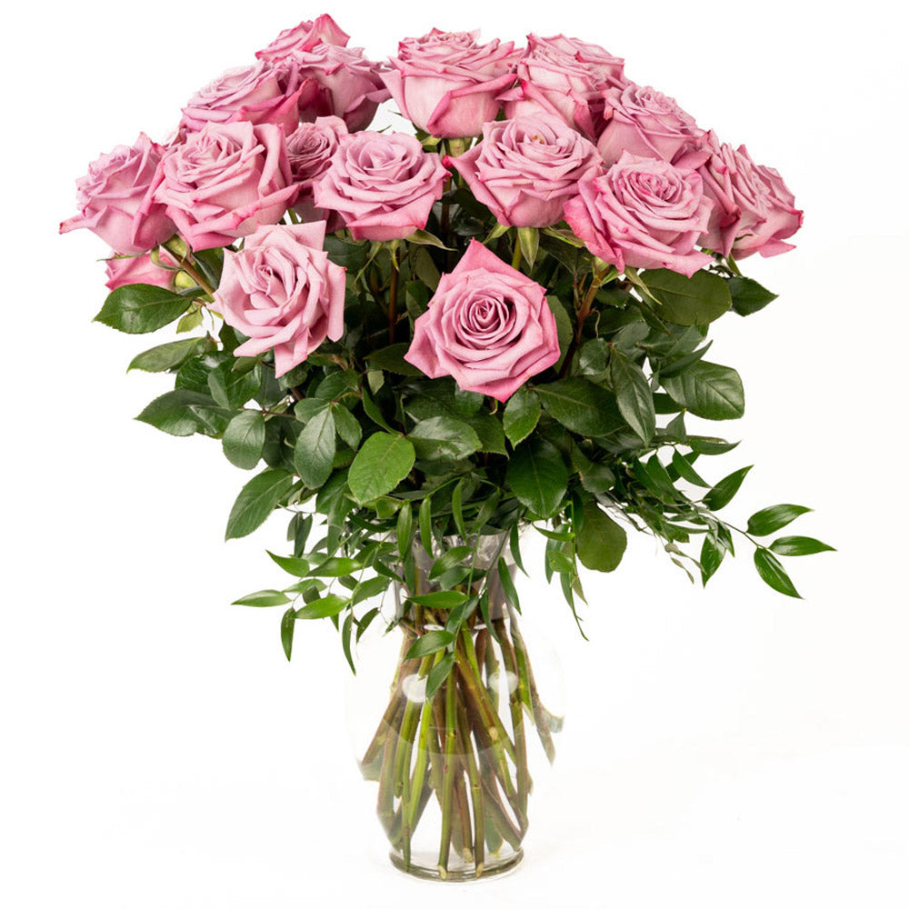 A bouquet of elegant pink roses arranged in a clear glass vase, perfect for any occasion.