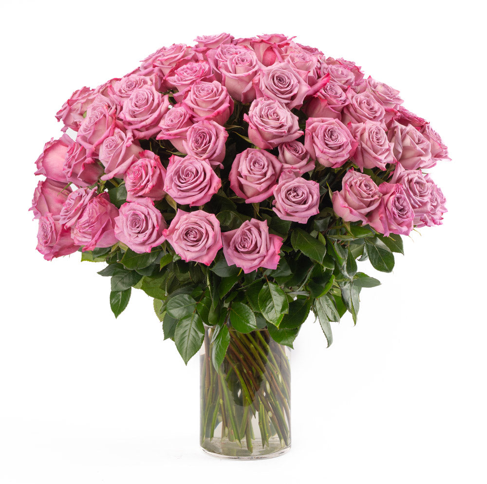 A stunning bouquet of pink roses in a clear vase, perfect for romantic gestures or special occasions.