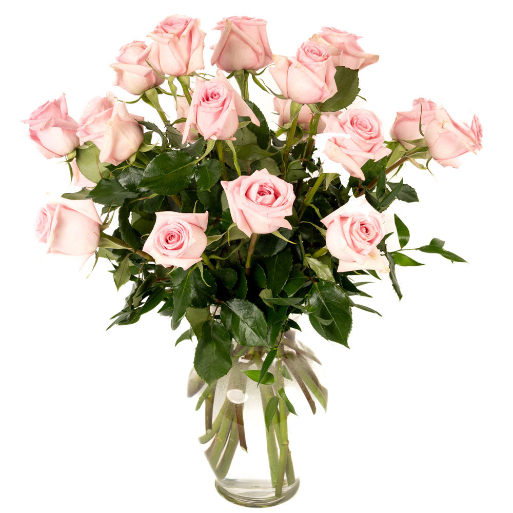 A beautiful bouquet of pink roses arranged in a clear glass vase, perfect for any occasion.