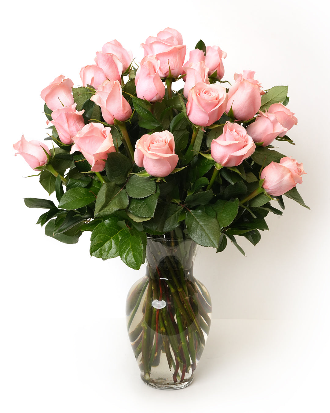 A stunning bouquet of 20 pink roses elegantly arranged in a clear glass vase.