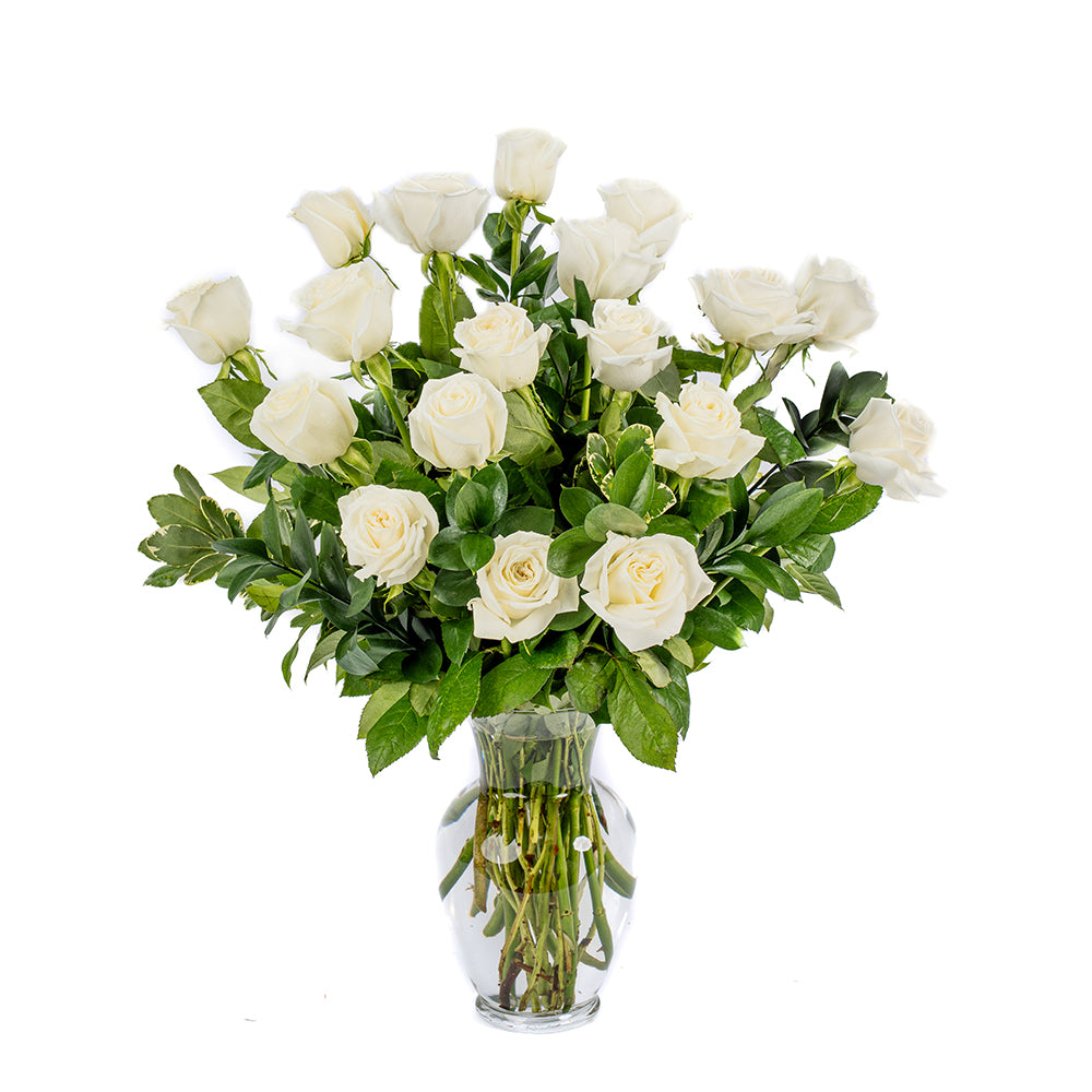 A beautiful bouquet of white roses arranged in a clear glass vase, perfect for any occasion.