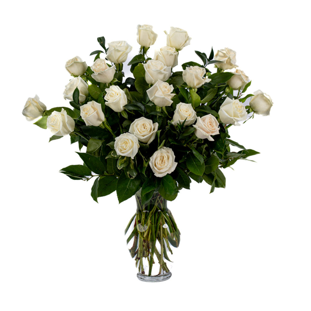 A beautiful bouquet of white roses arranged elegantly in a clear glass vase.