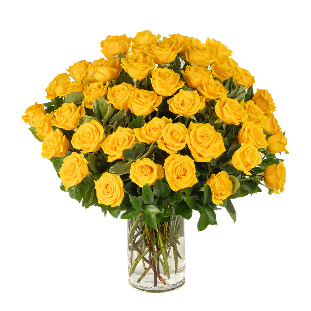 A vibrant bouquet of fresh yellow roses arranged in a clear glass vase, perfect for brightening any occasion.